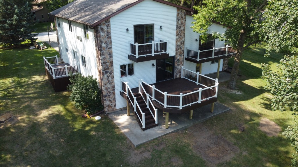 Elevated Trex Transcend Island Mist composite deck attached to a white house